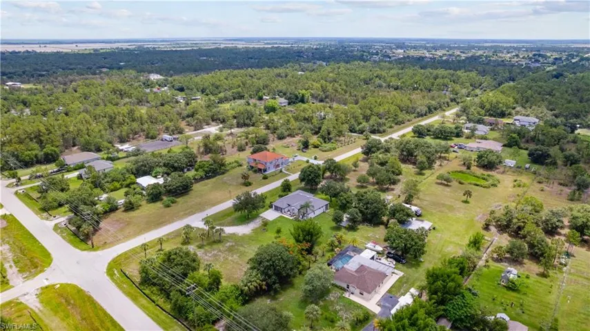 Aerial perspective showcasing a residential area amidst expansive green spaces