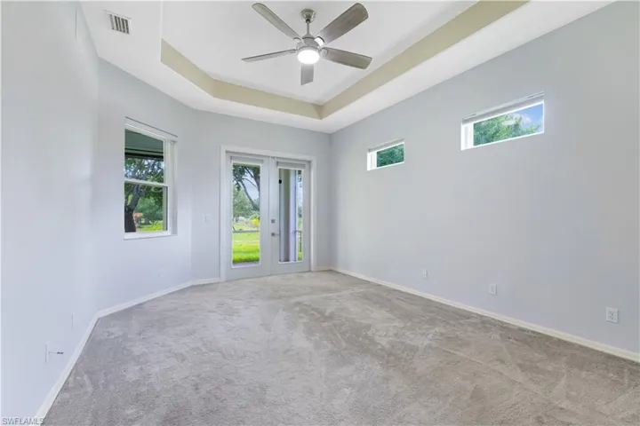 Spacious room featuring gray carpeting and light blue walls