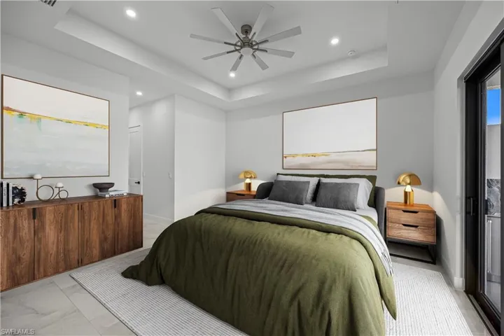 Master Bedroom DIGITALLY STAGED featuring ceiling fan and a raised ceiling