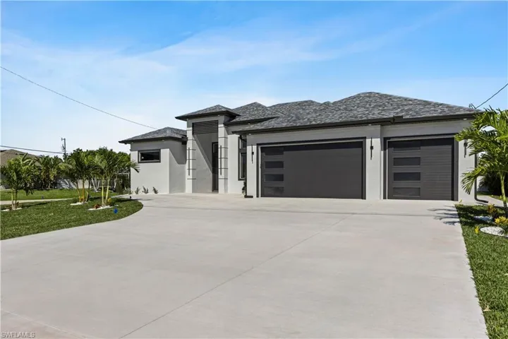Front view of the  home featuring a 3 car garage
