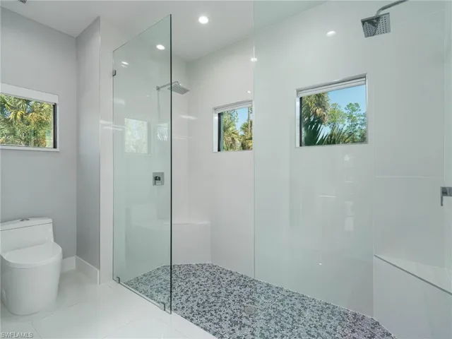 Full bath featuring walk in shower and tile patterned flooring