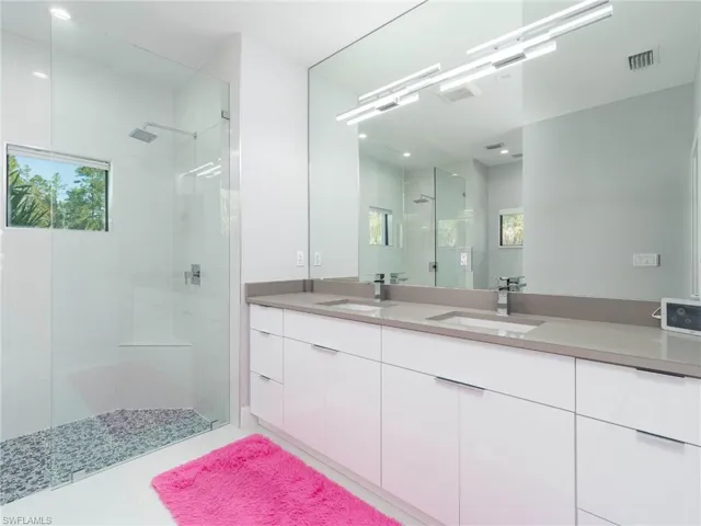 Bathroom with a shower stall and double vanity