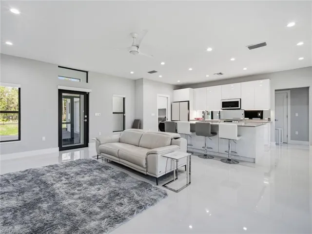 Living room featuring a ceiling fan and recessed lighting