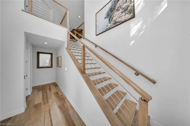 Unique, architectural oak and metal, contemporary stairs serve as a fabulous entry into this residence.