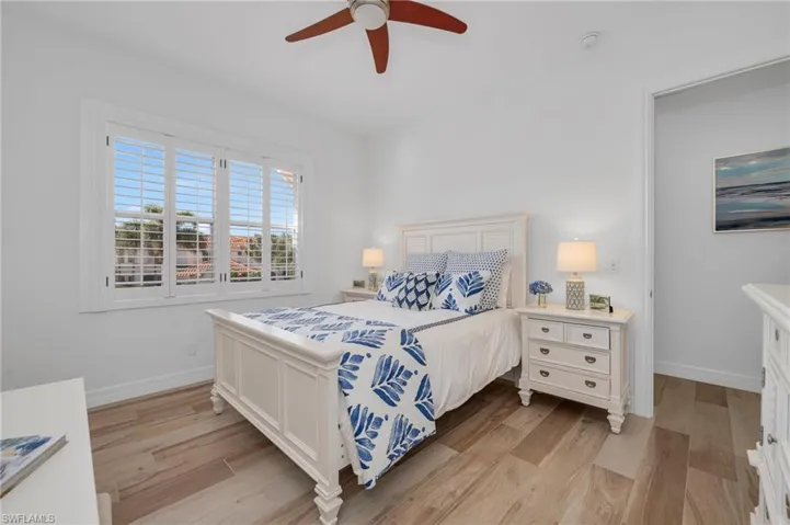 The ensuite bedroom has tile flooring, plantation shutters, and large, walk-in closet.