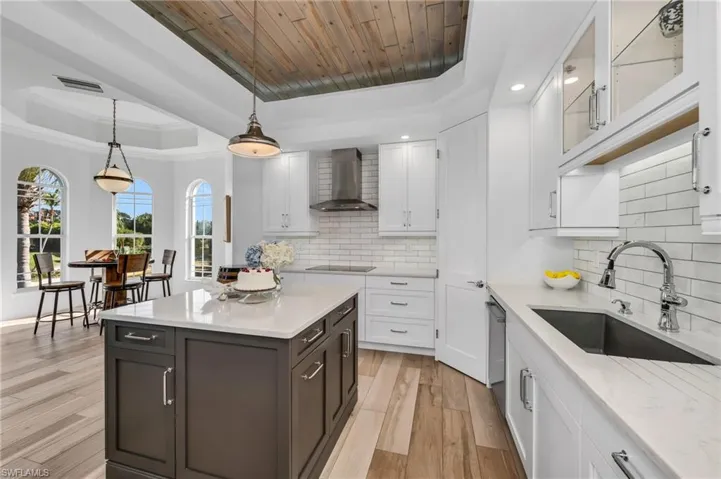 Bright and cheery with beautiful views, this kitchen comes equipped with induction cooktop, walk-in pantry, and ambient, lit, oak-beamed ceiling detail.