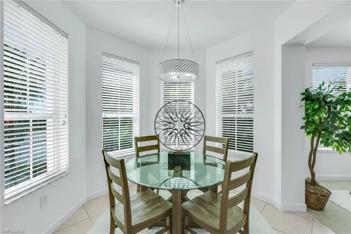 Dining space featuring light tile patterned flooring and baseboards