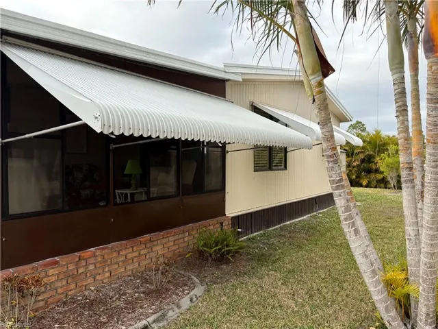 View of side of home featuring a yard