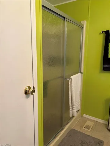 Bathroom with tile patterned flooring and walk in shower