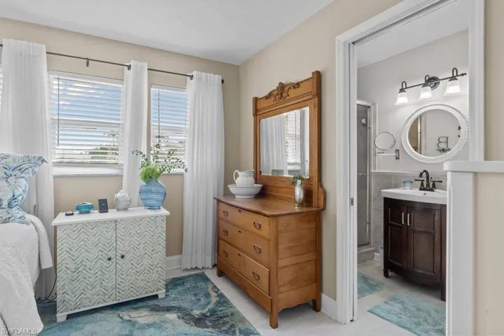 Full bath with vanity and baseboards