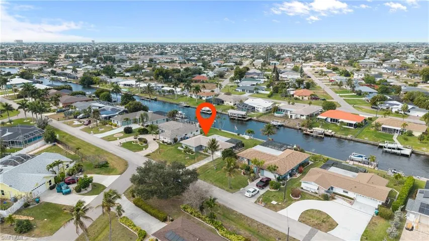 Aerial view of property's location featuring nearby suburban area and a large body of water