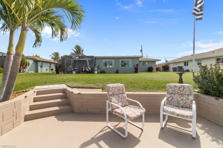 View of patio featuring a lanai