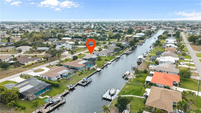 Aerial perspective of suburban area featuring a large body of water