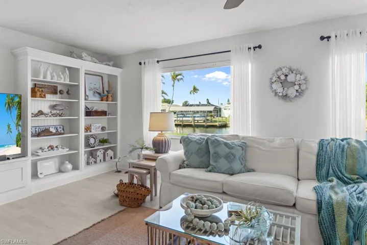 Living area with wood finished floors and ceiling fan