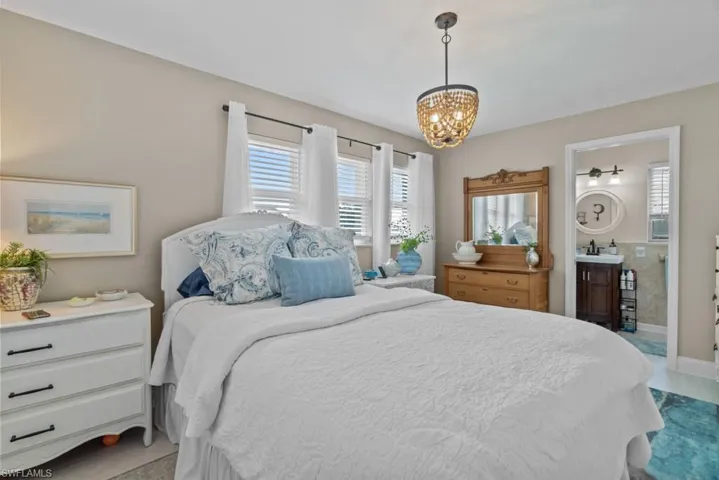 Bedroom with a chandelier and ensuite bathroom