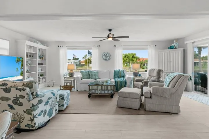 Living area with ceiling fan and healthy amount of natural light