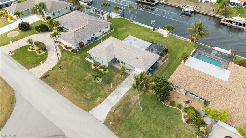 Aerial view of residential area featuring a nearby body of water