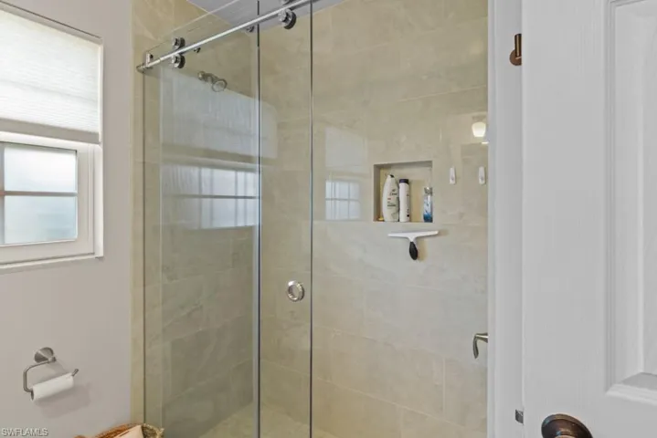 Full bathroom featuring a stall shower