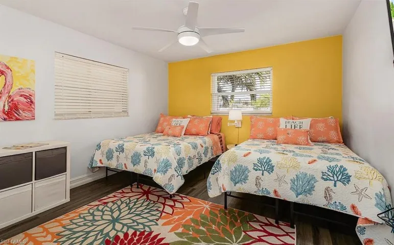 Bedroom with ceiling fan, wood finished floors, and baseboards