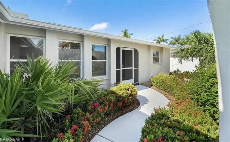 Property entrance featuring stucco siding