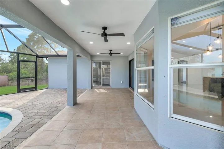Unfurnished sunroom with ceiling fan