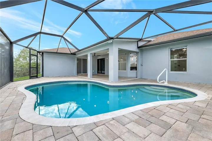 Pool featuring a lanai, a patio, and ceiling fan