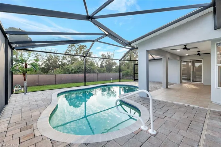 View of pool featuring a fenced backyard, a lanai, a ceiling fan, a fenced in pool, and a patio area
