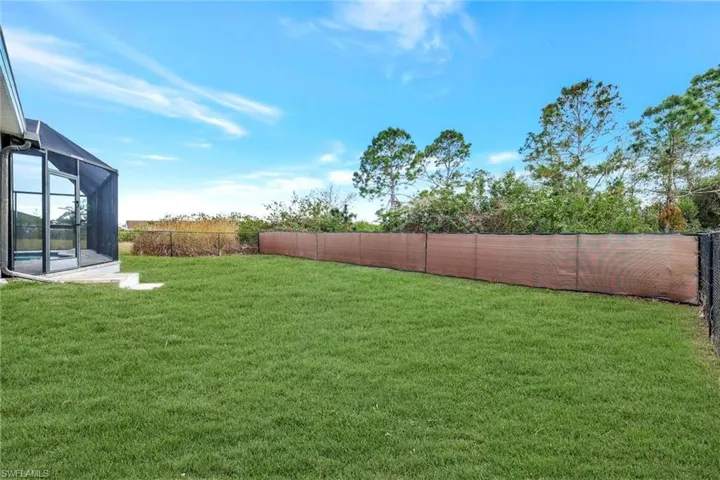 View of yard with a lanai and a fenced backyard