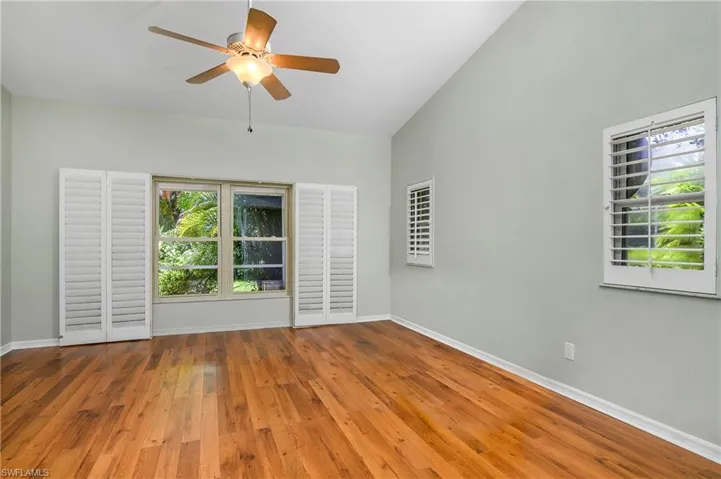 style flooring, high vaulted ceiling, and ceiling fan