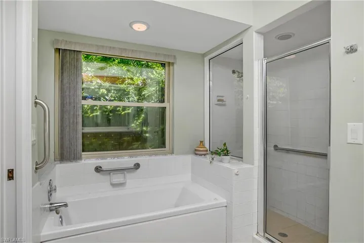 Bathroom featuring shower with separate bathtub