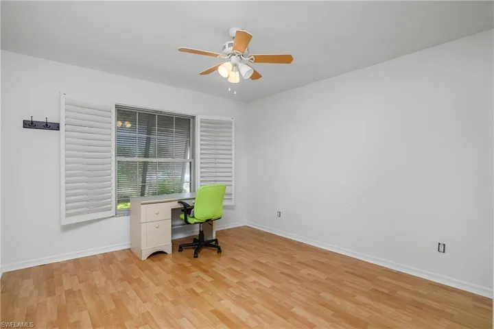 Unfurnished office with ceiling fan and light hardwood / wood-style flooring