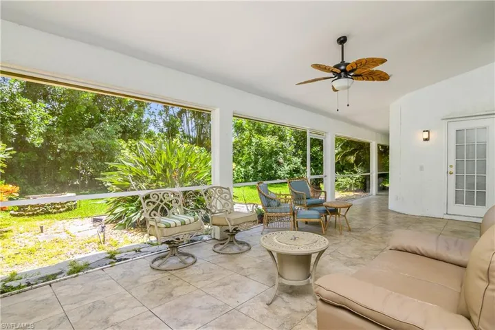 Unfurnished sunroom featuring ceiling fan
