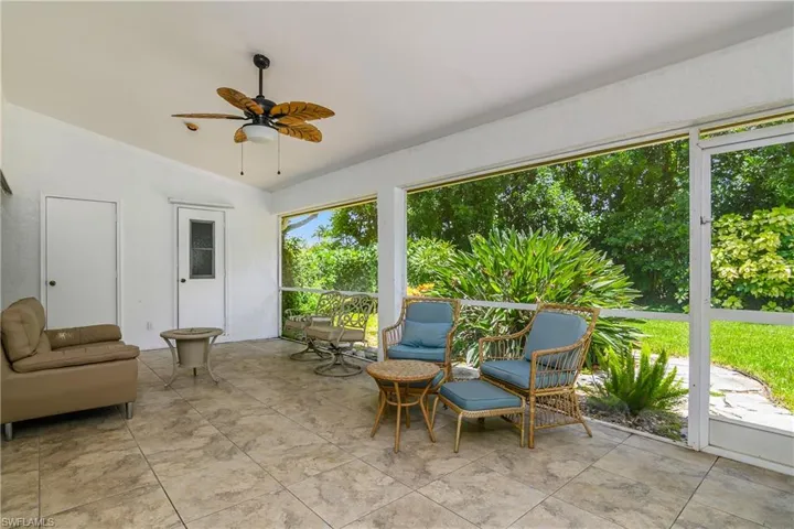 Sunroom / solarium featuring ceiling fan and vaulted ceiling