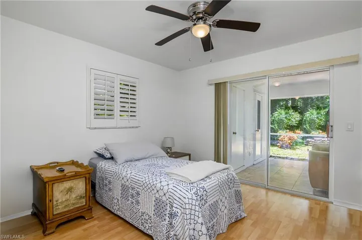 Bedroom featuring light hardwood / wood-style flooring, access to outside, and ceiling fan