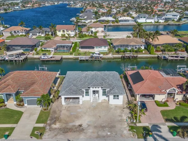 Birds eye view of property with a water view