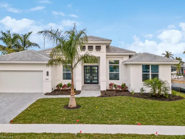 View of front of home featuring a front yard and a garage