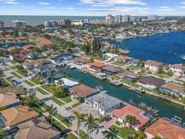 Birds eye view of property with a water view