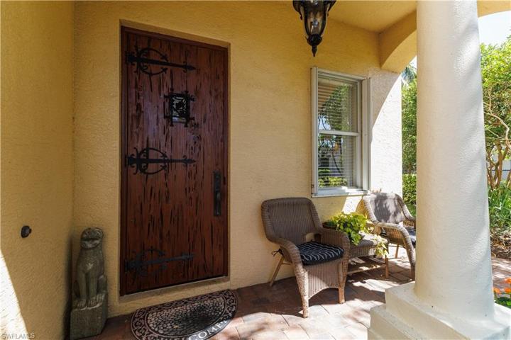 Custom front door, pecky cypress with wrought iron peek through window