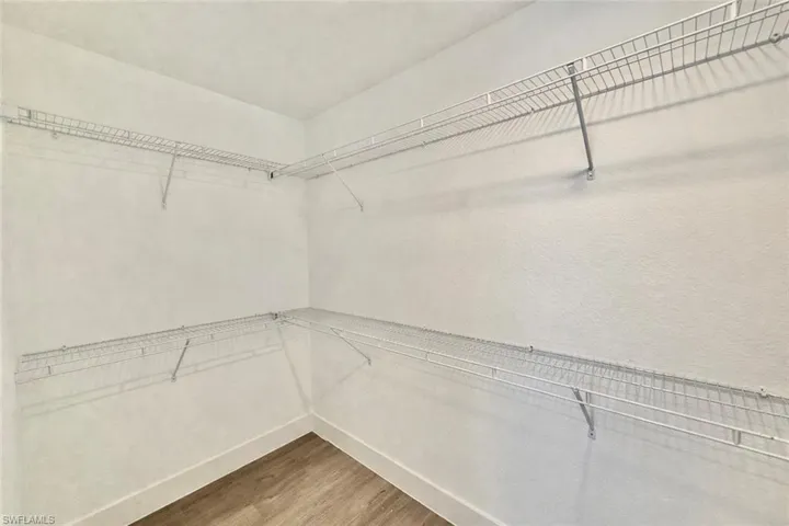 Walk in closet featuring light wood-style floors