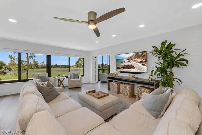 Living room featuring recessed lighting, a ceiling fan, and wood finished floors