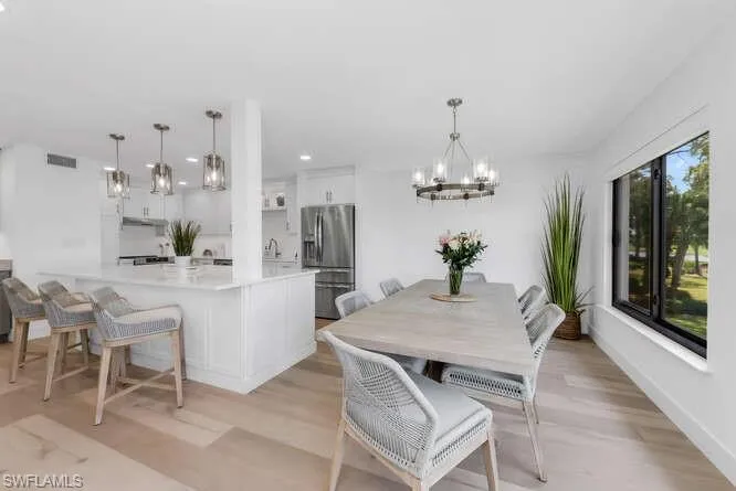 Dining area featuring a chandelier, recessed lighting, and light wood-type flooring