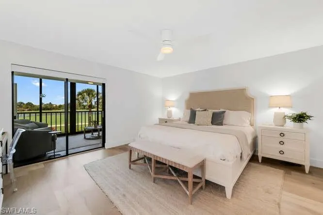 Bedroom with access to outside, light wood-style flooring, and a ceiling fan