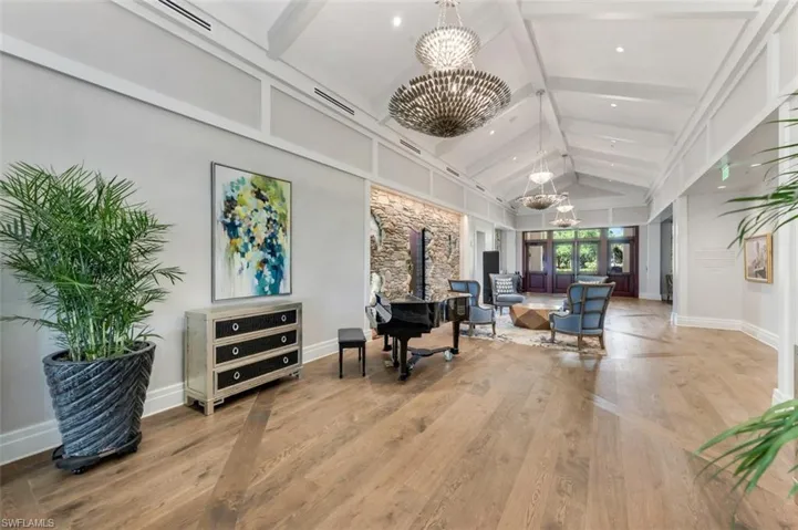 Building lobby featuring beamed ceiling and high vaulted ceiling