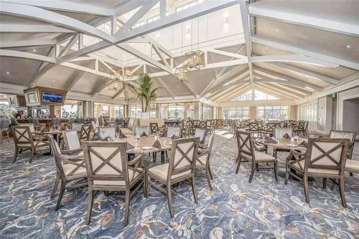 Dining room with high vaulted ceiling, beam ceiling, and carpet