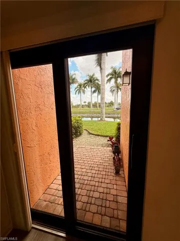 Back sliding glass door from kitchen featuring a water view