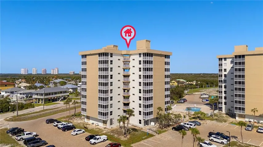 View of property with uncovered parking