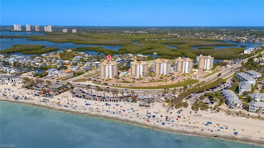 Birds eye view of property featuring a city view, a beach view, and a water view