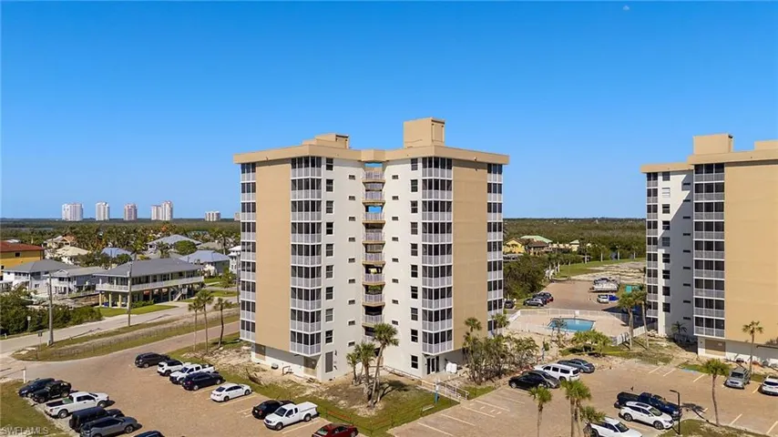 View of building exterior featuring uncovered parking