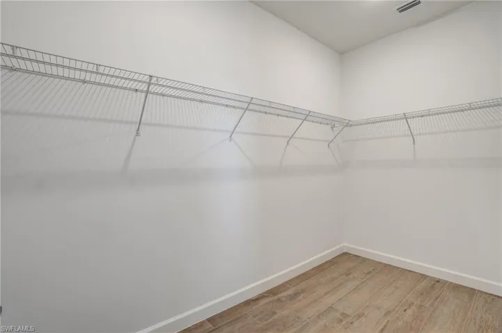 Spacious closet with light wood-style floors