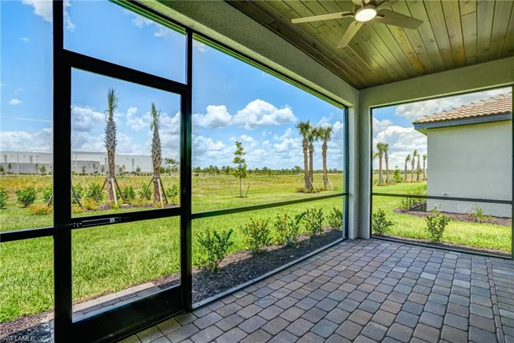 Unfurnished sunroom with a ceiling fan and plenty of natural light